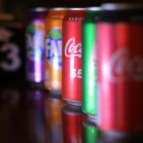 Close-up of vibrant soft drink cans lined up with selective focus.